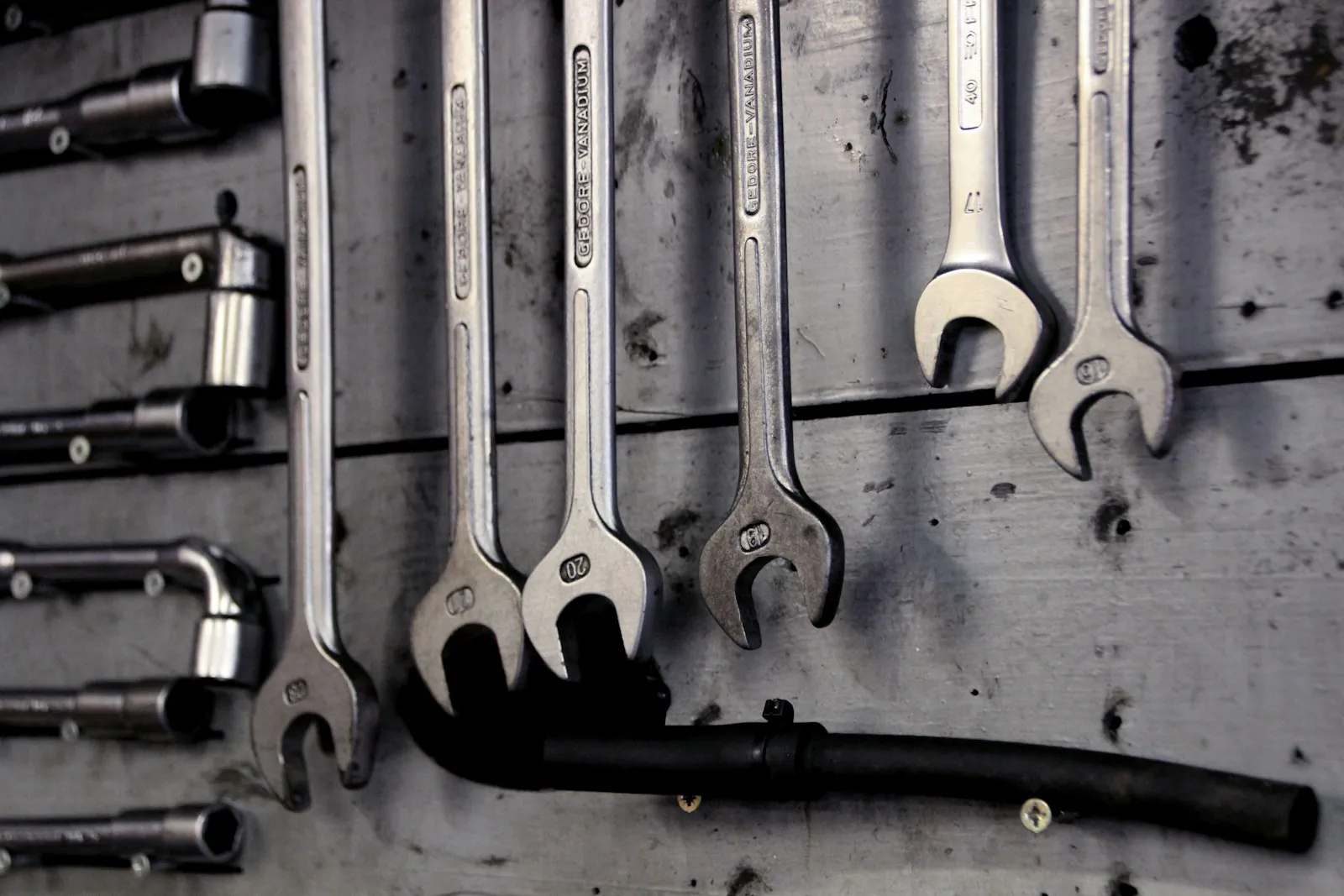 Row of spanners hanging on a workshop wall