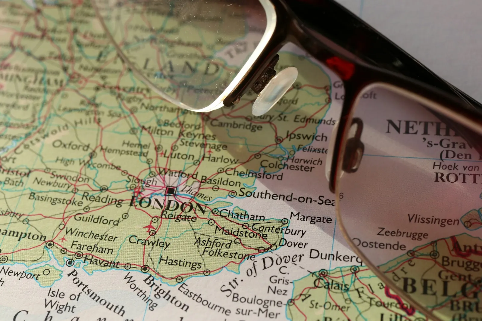 Reading glasses resting on a road map