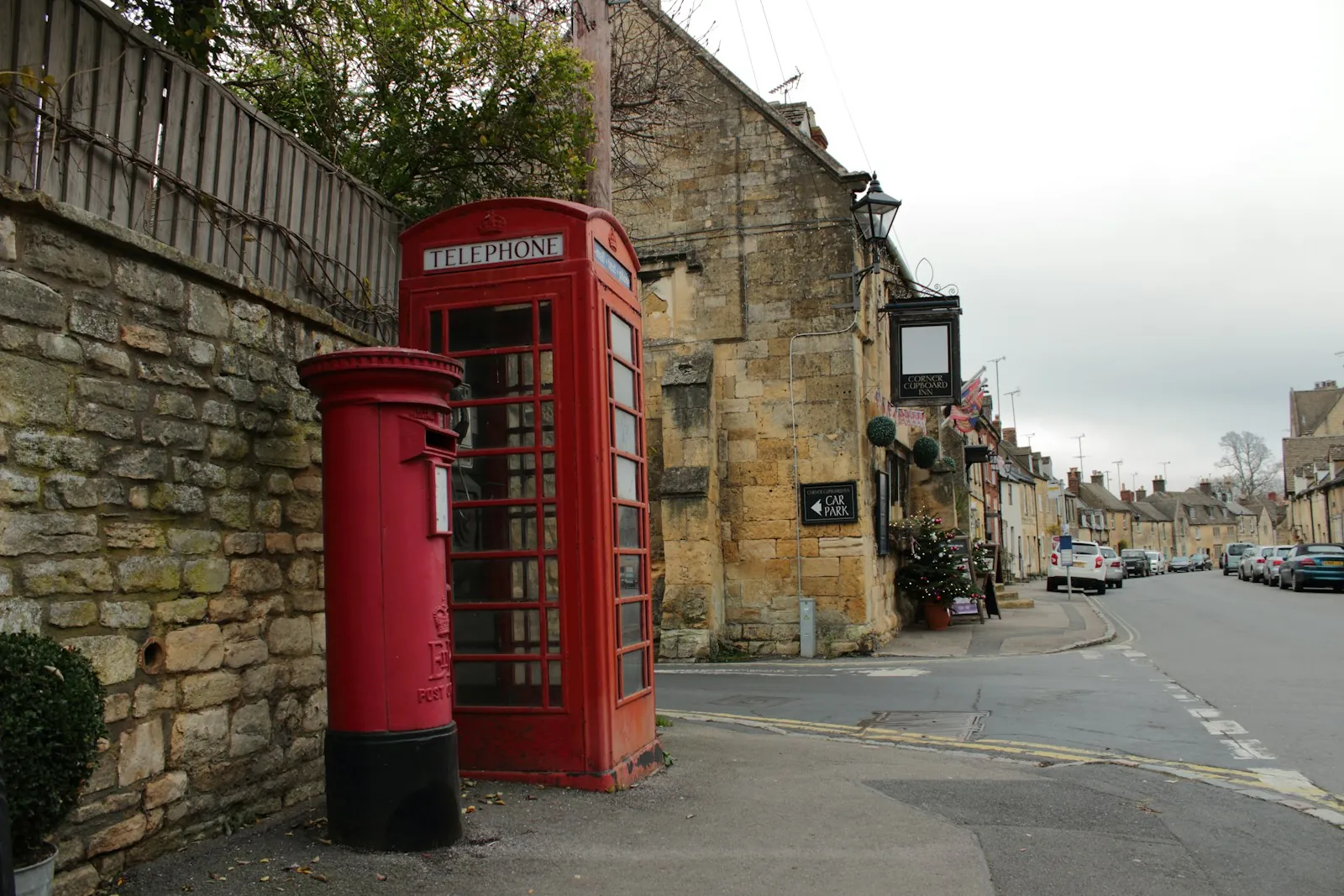Red telephone box and post box on an English village street