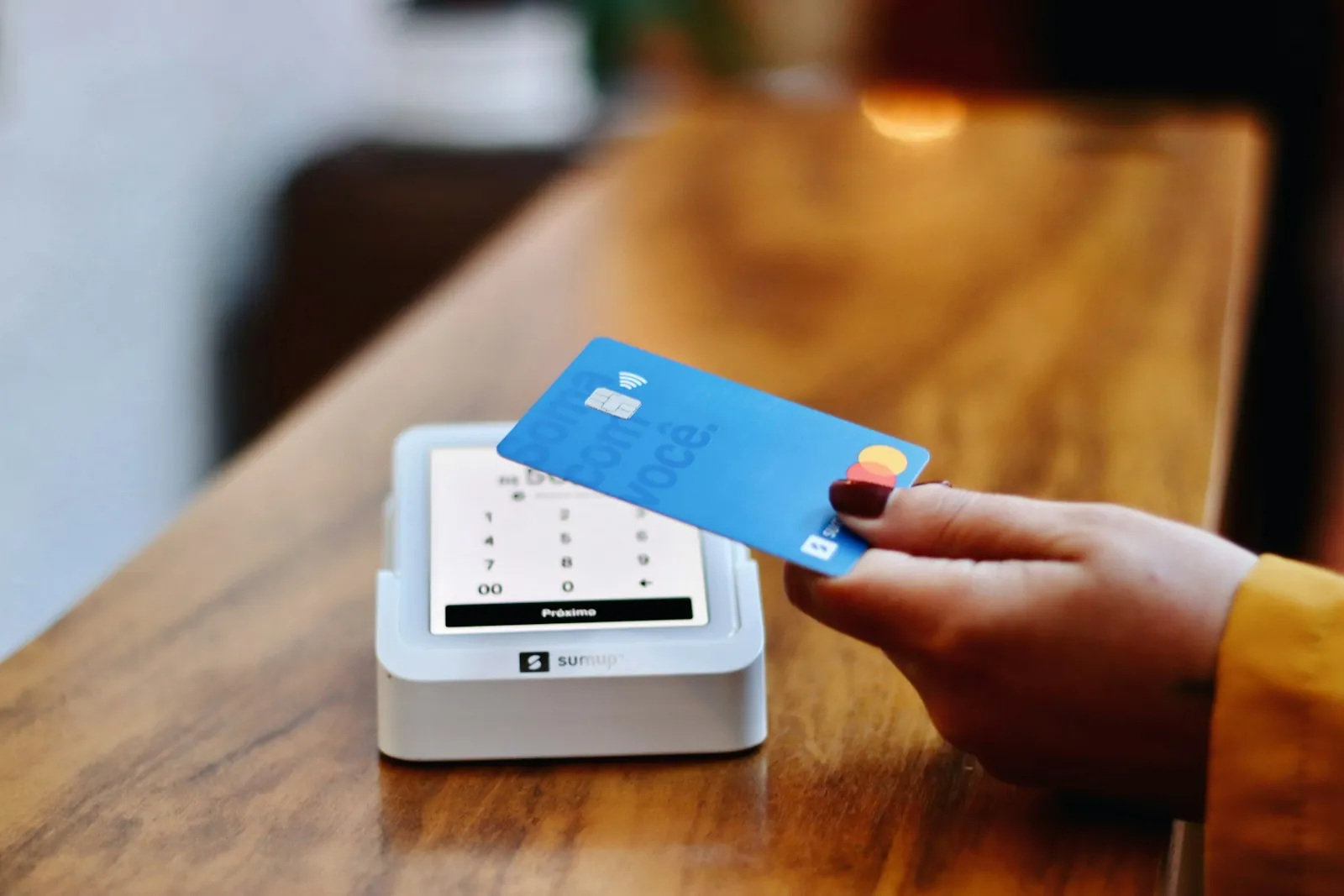 Customer paying by card at a shop counter