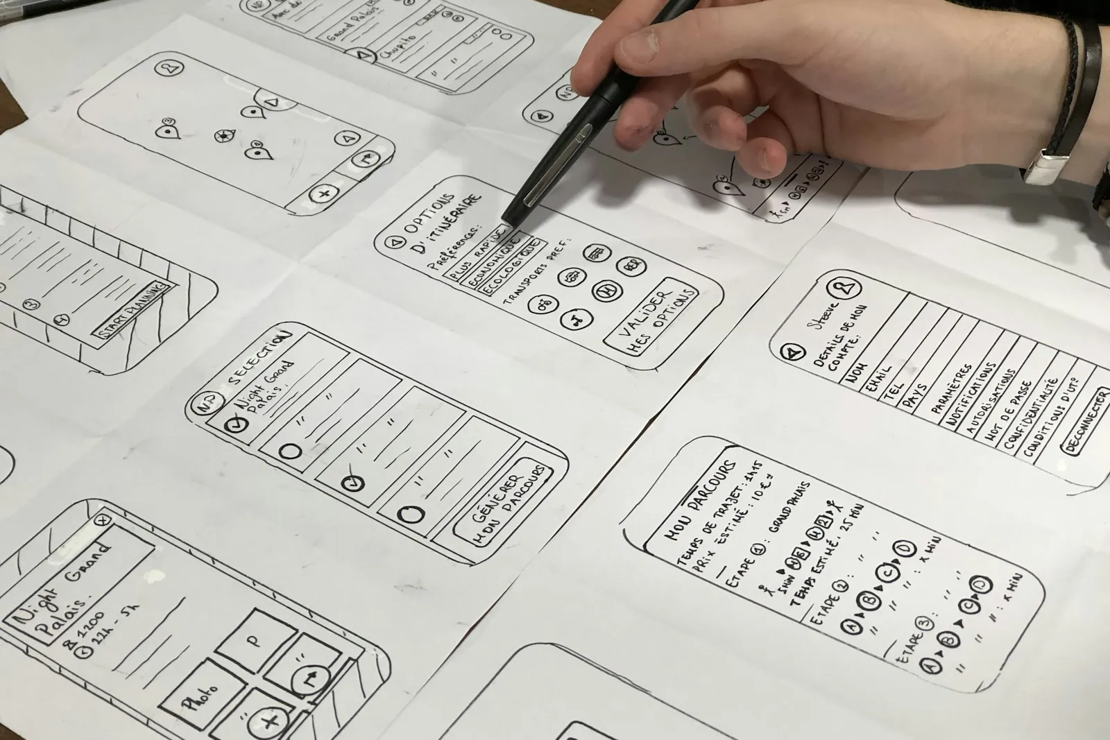 Hand drawing mobile app wireframes on paper