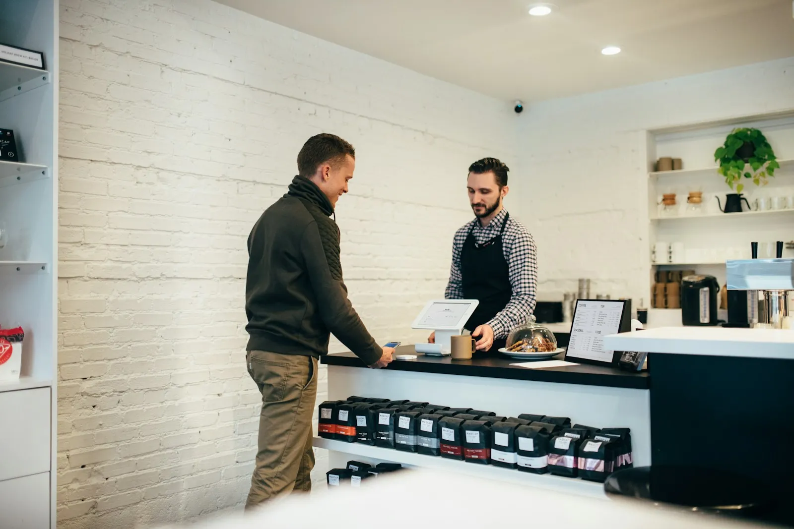 Shopkeeper serving a customer at the counter