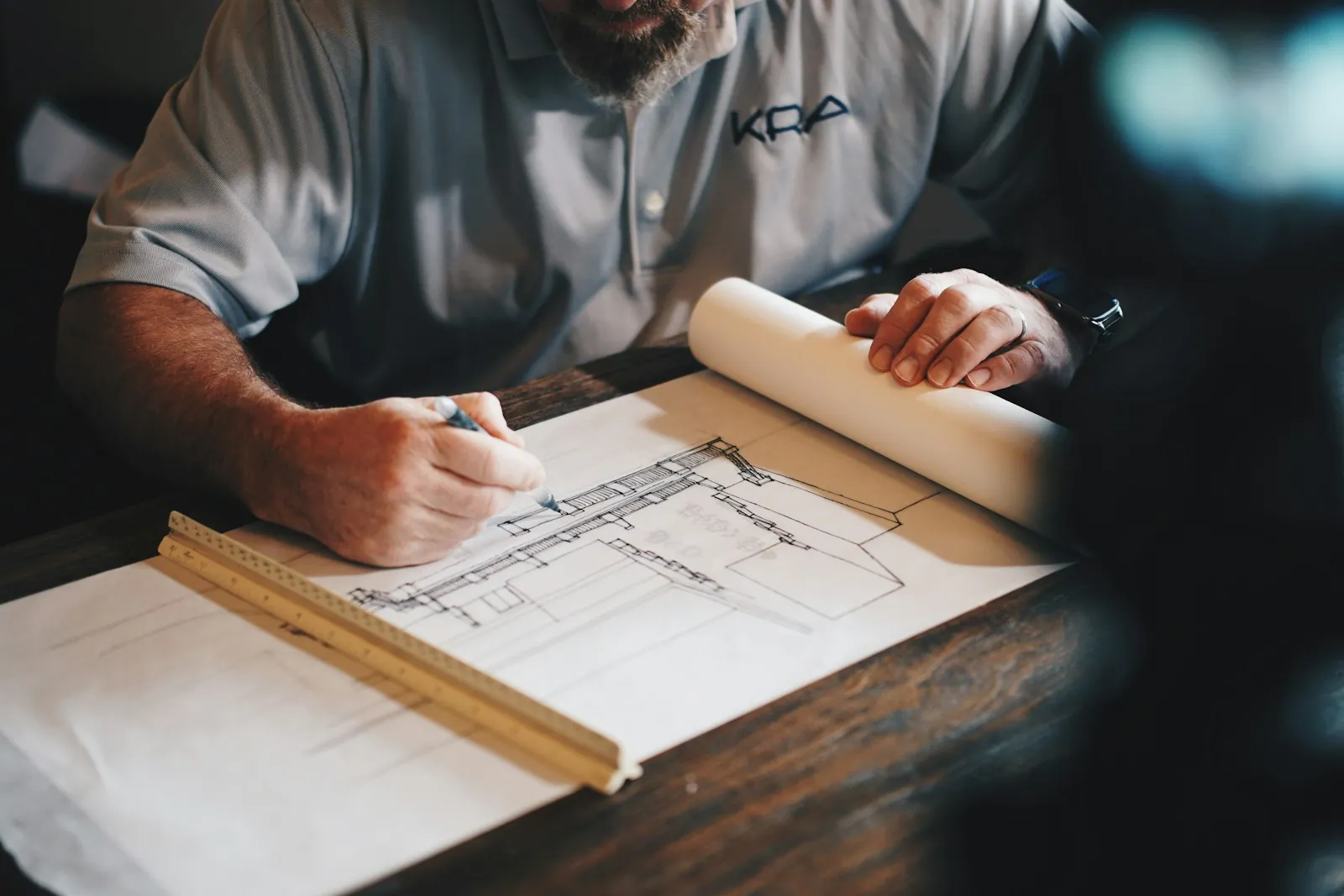 Architect drafting detailed plans with a ruler